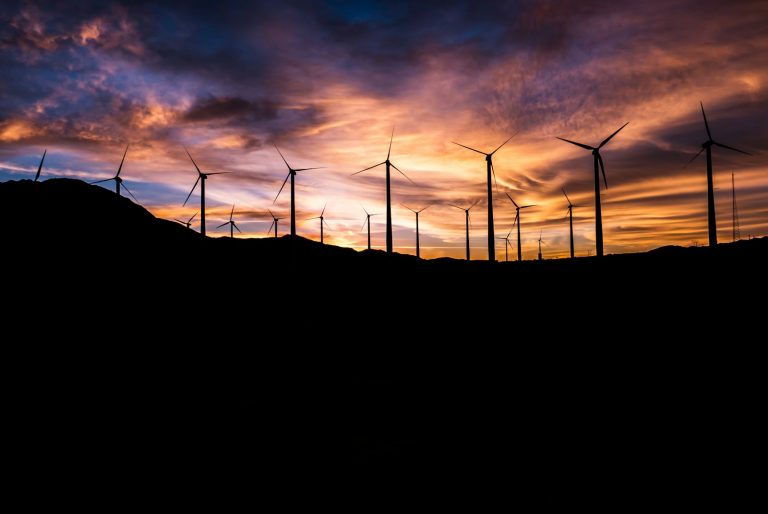 silhouette of windmills during golden hour, renewable energy, energi terbarukan